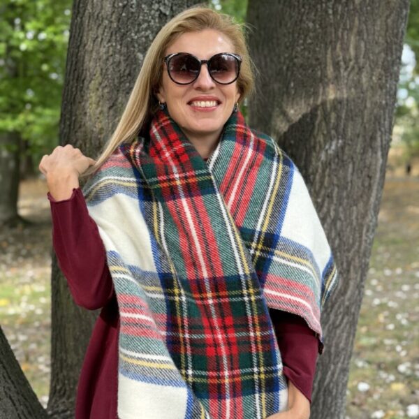 Cream scarf with red and green checks and navy accents draped over the shoulders — front view